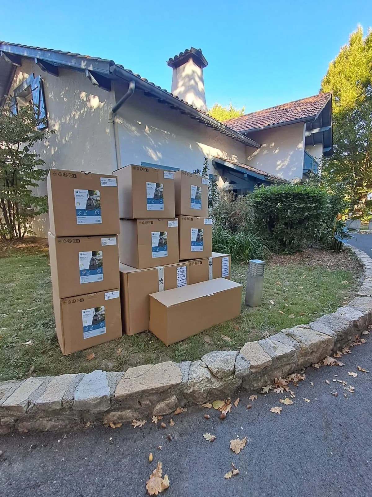 Des cartons d'équipement empilés devant une villa avant le début du chantier